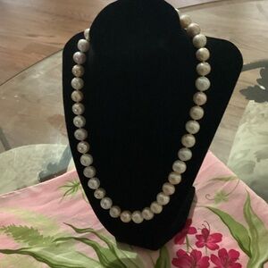 18 inch necklace with white, tan, and light pink pearls.